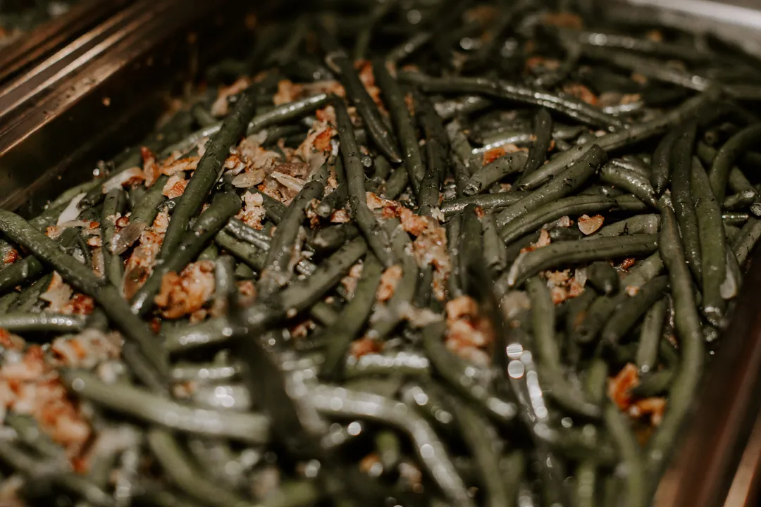 Close-up of green beans with crispy fried onions in a chafing dish on the wedding buffet