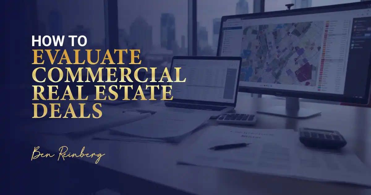 Office desk with papers, calculator, and screens showing real estate maps and data charts.