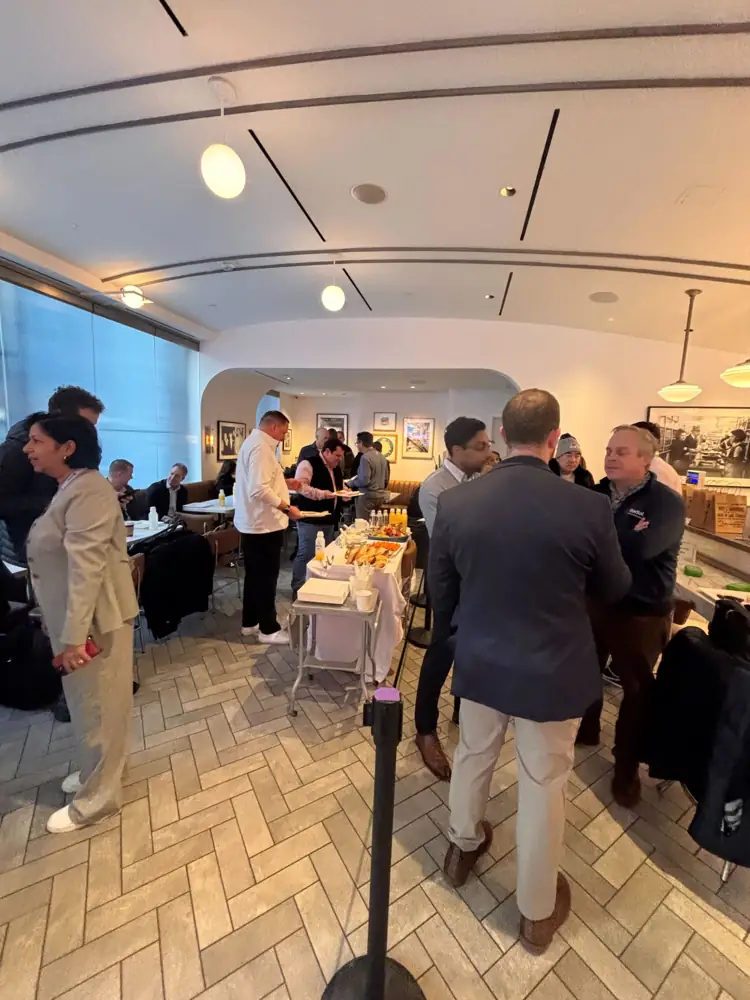 Attendees gathered in a diner-style room at a breakfast buffet