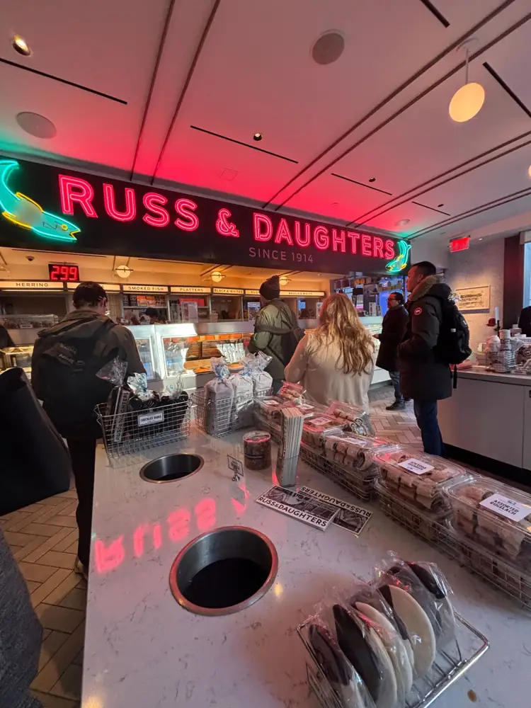 The Russ and Daughters counter with neon signage and baked goods