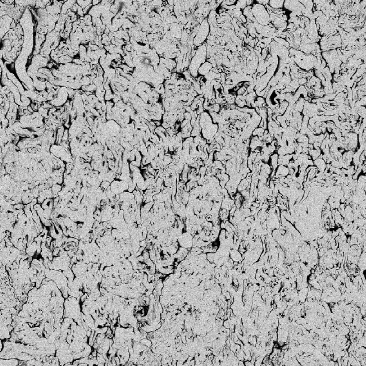 A mosaic SEM image of a porous tablet with a complex network of pores formed by the compaction of spray dried dispersions.