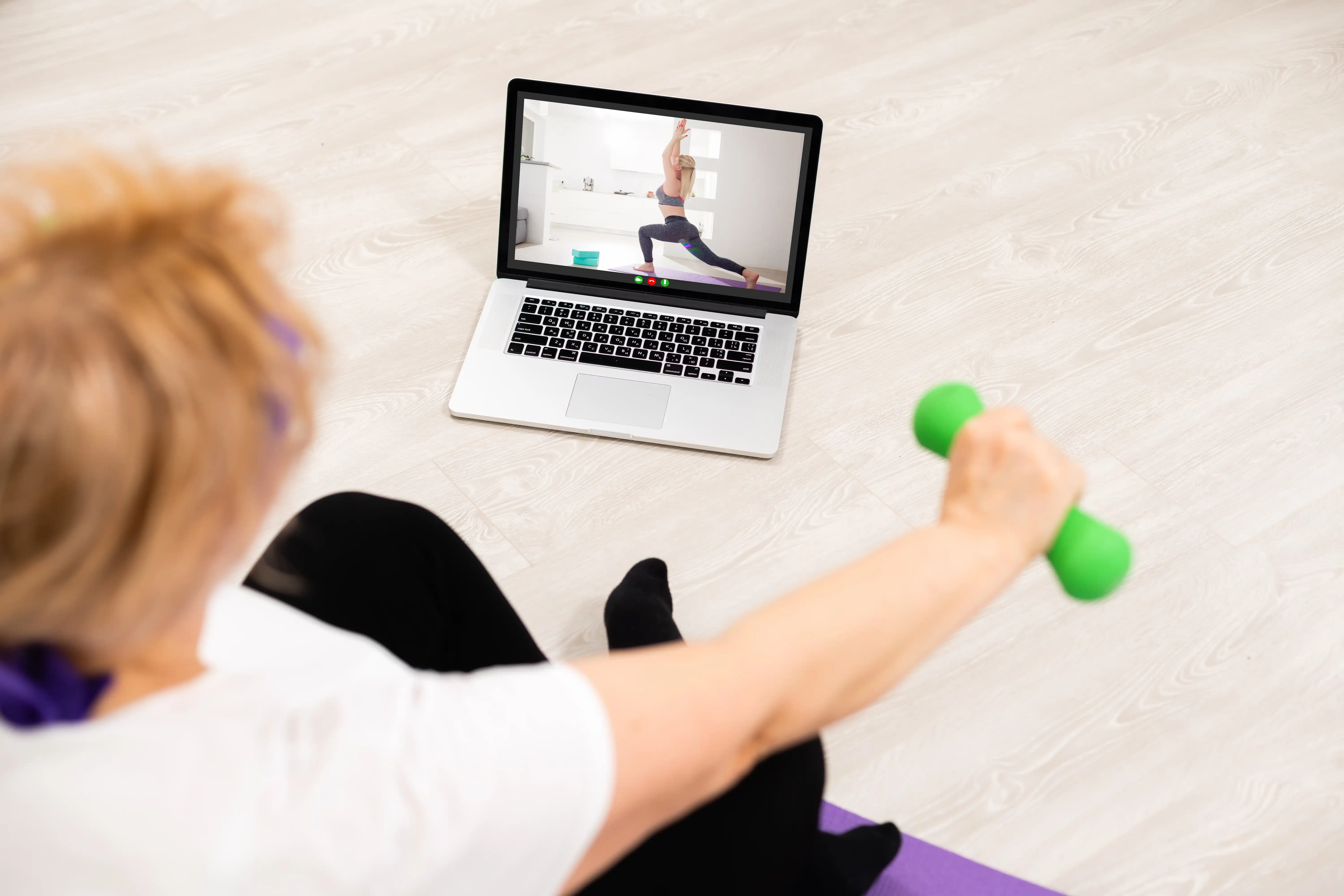 Patient doing virtual physical therapy at home through a laptop