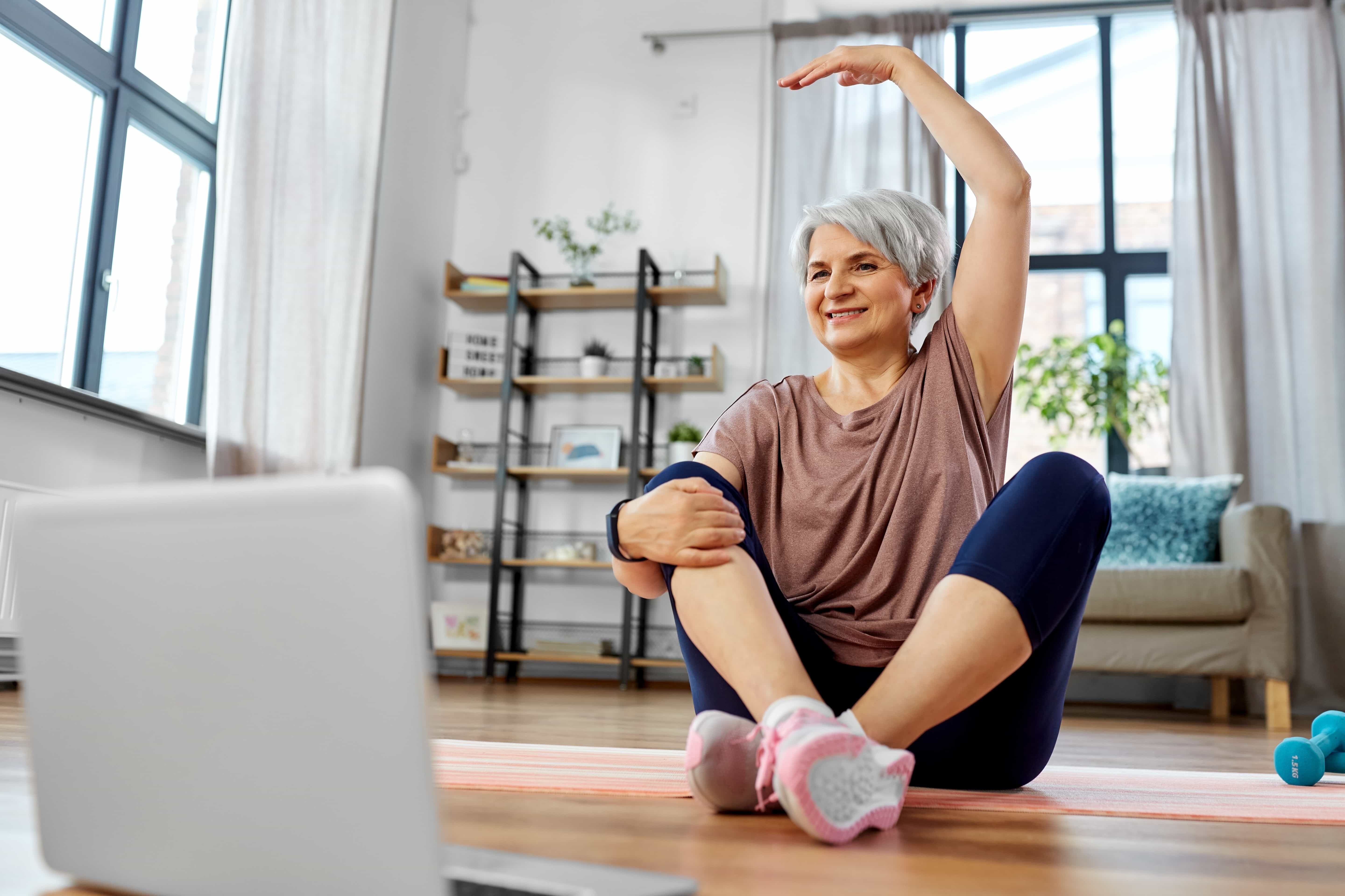 Patient doing virtual physical therapy at home through a laptop