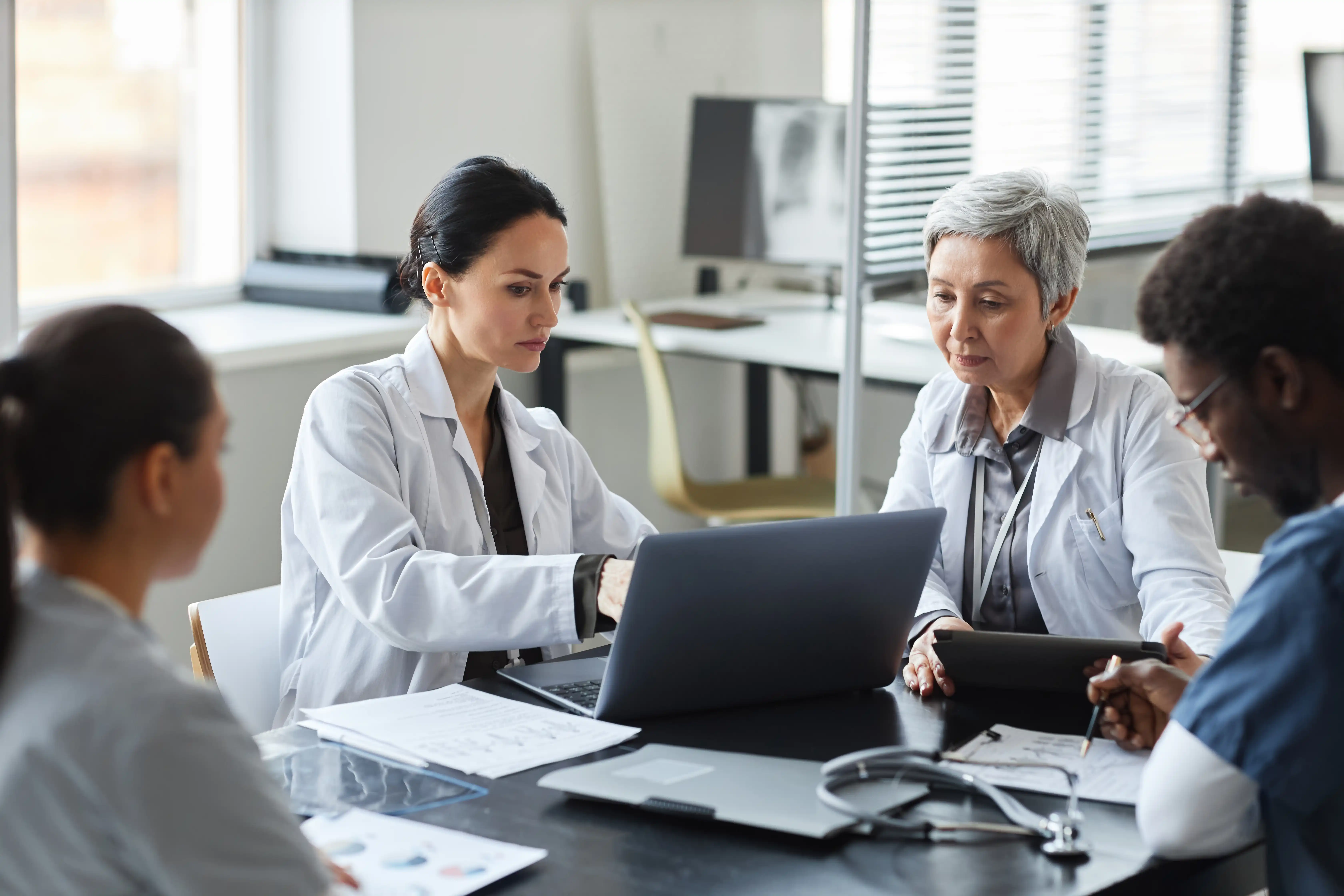 Two providers viewing laptop and discussing CMS TEAM regulations