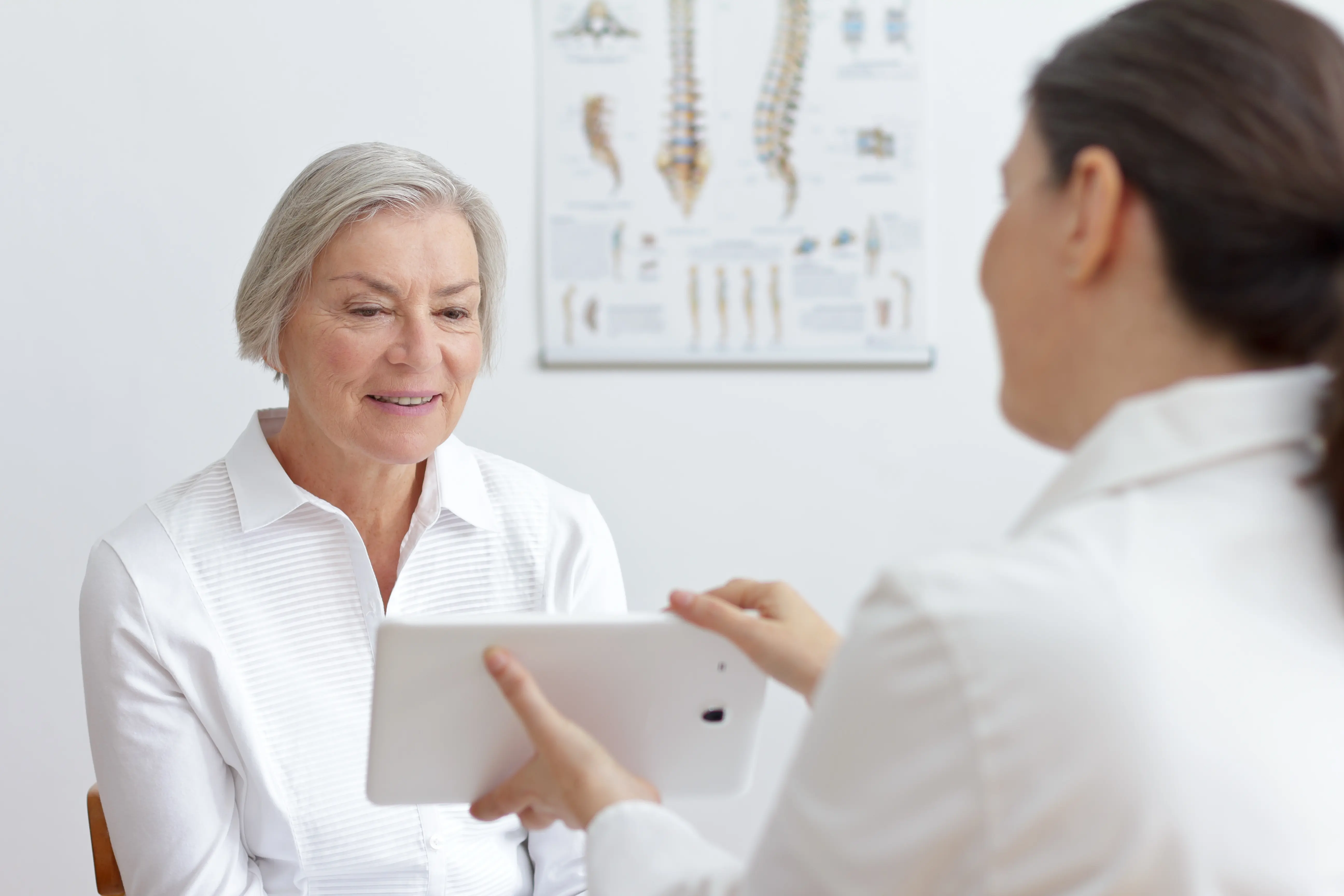 Physician delivering patient education on care plan using tablet