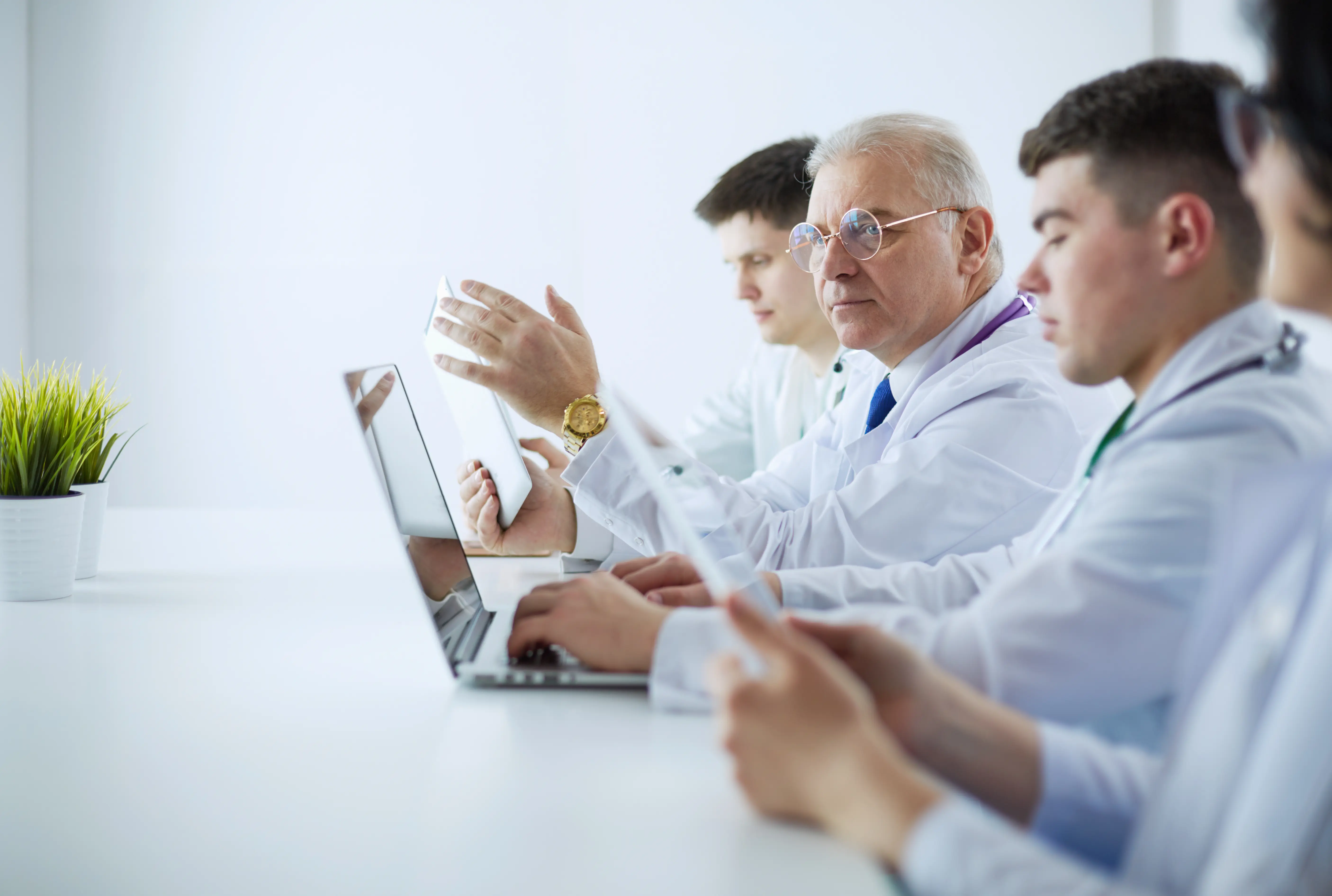 Doctors and care team discussing care fragmentation reduction strategies.