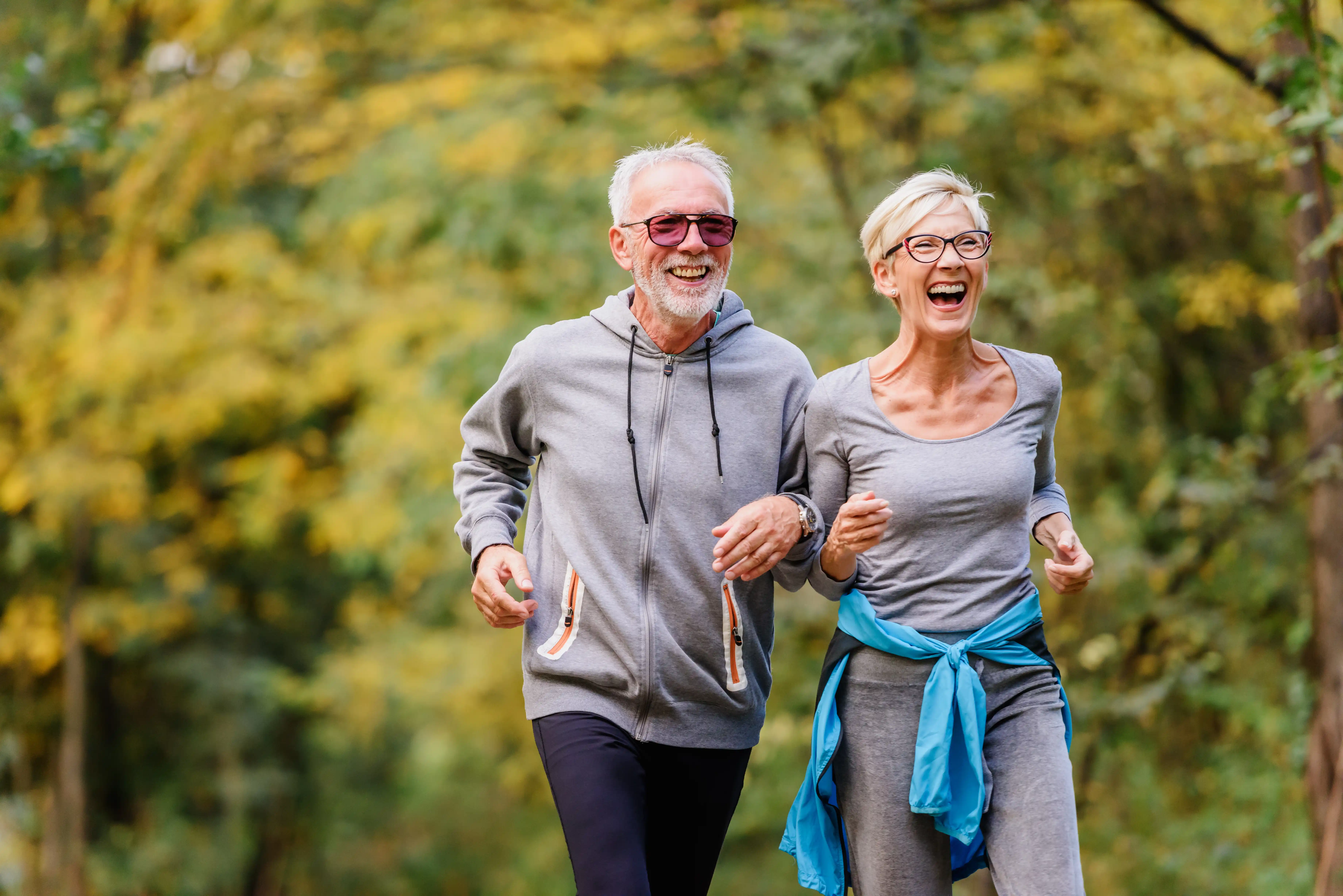 Elderly couple enjoying a jog outdoors, having completed at-home recovery following total joint replacement surgery using Force Therapeutics.