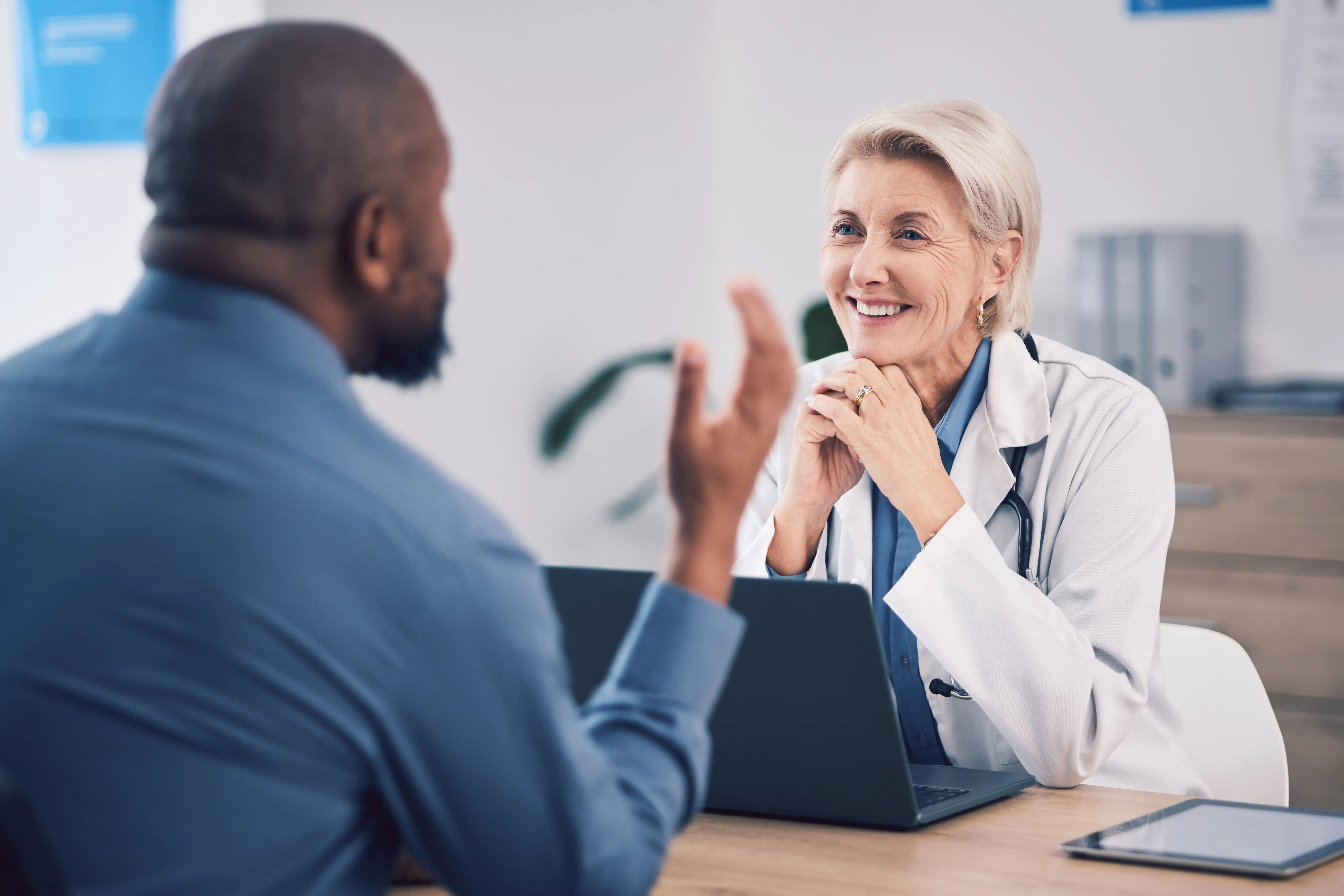 Two orthopedic surgeons having a private discussion at AAOS 2026.