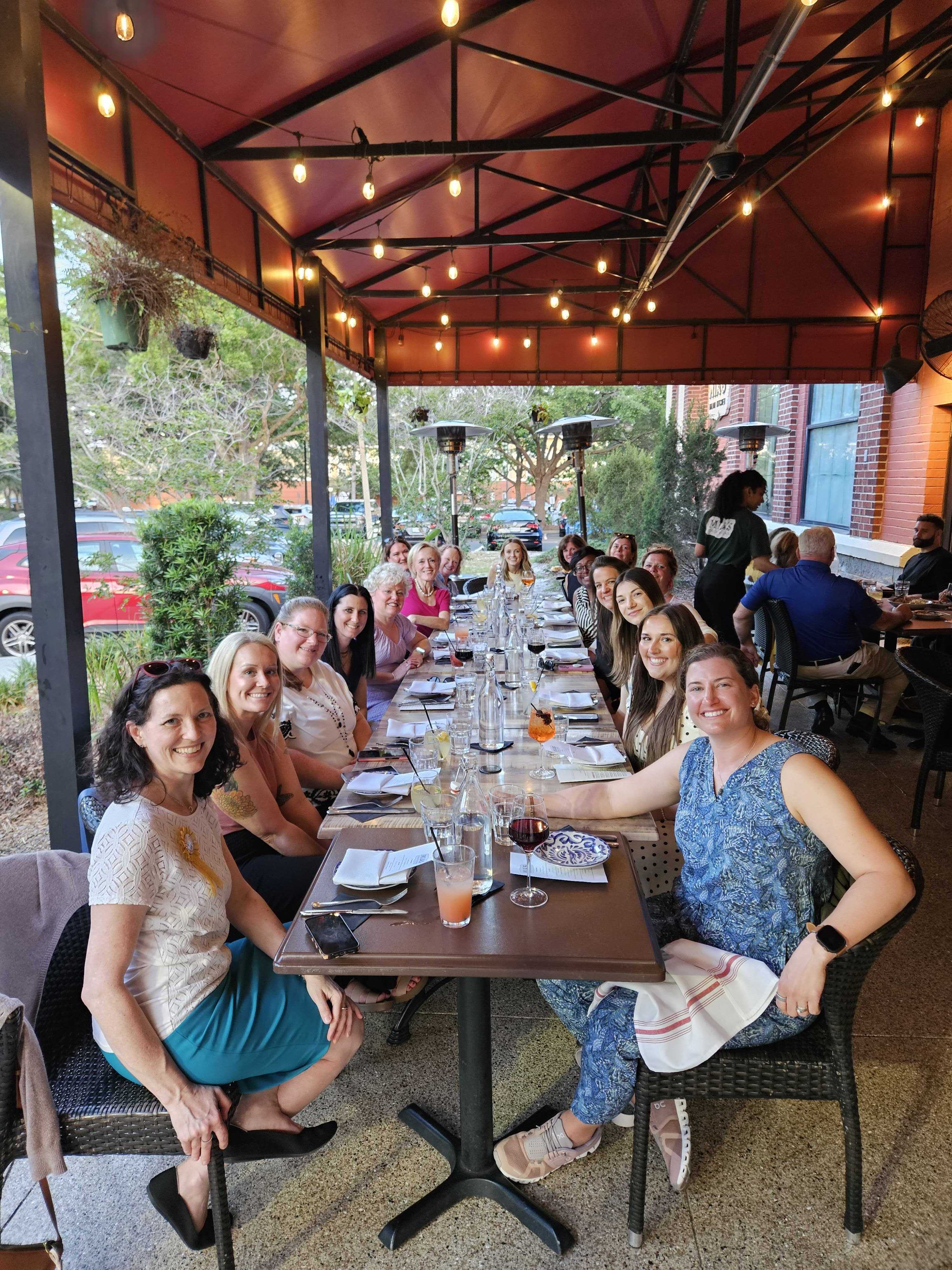 Nurse navigator and care coordinators around a dinner table on the sidelines of NAON 2026, joined by Force Therapeutics' sales team