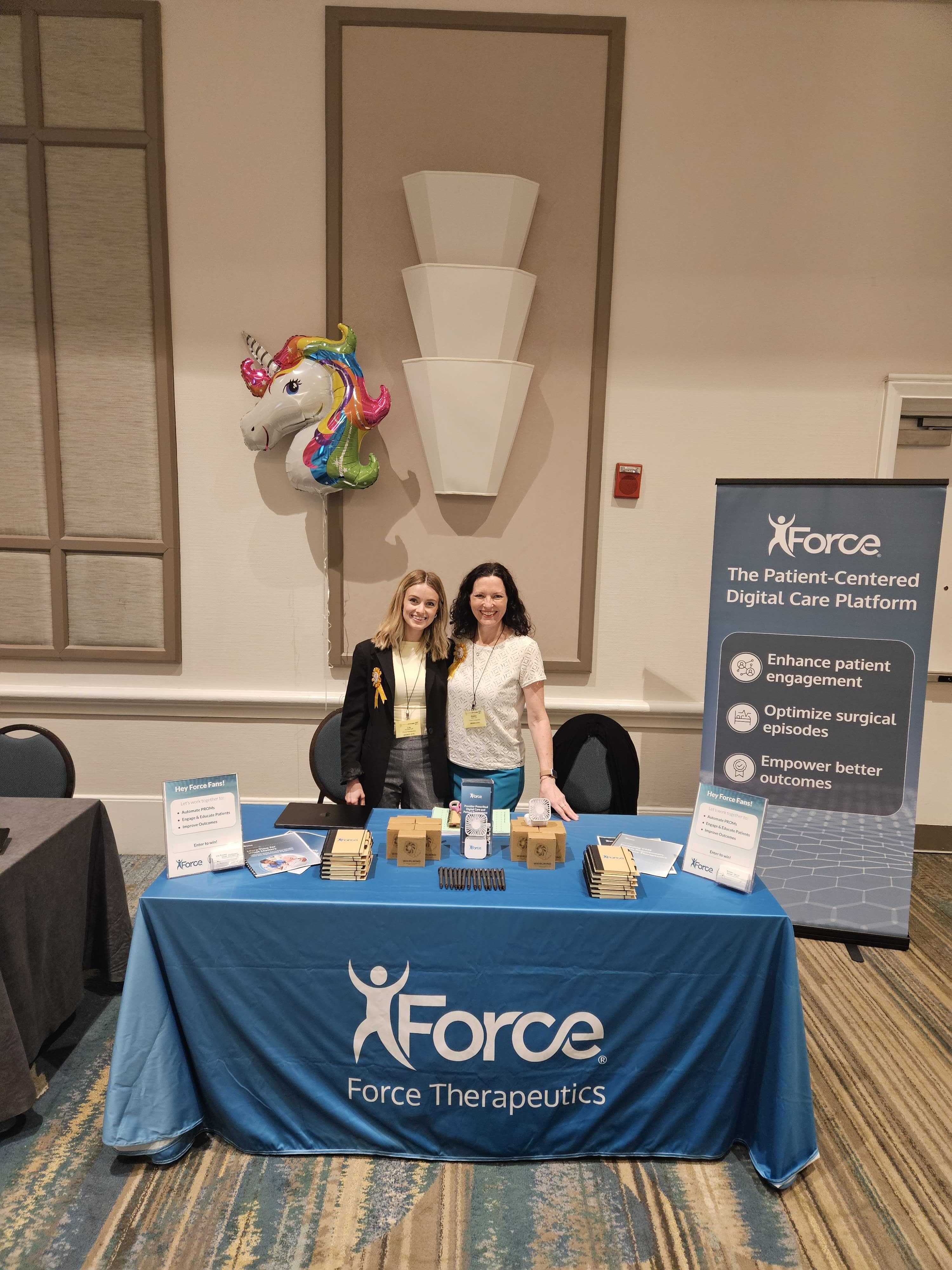 The Force Therapeutics team behind their booth at NAON 2026