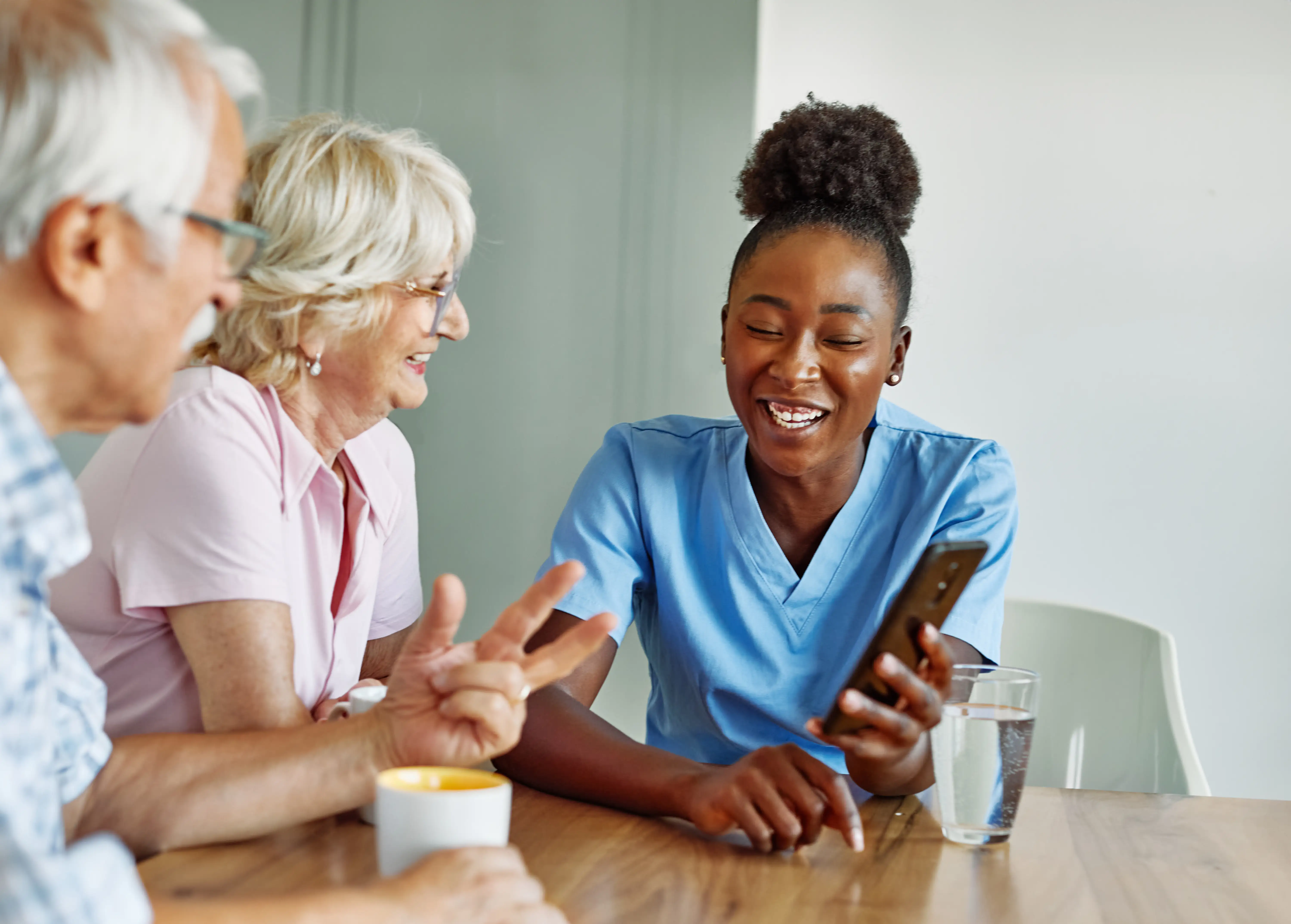 Clinician showing Force Therapeutics mobile app to Total Joint Replacement patient and care partner