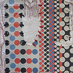 Close-up of a multi-patterned textile with red, blue, black, and beige circles and diamond shapes, showing some worn and torn areas.