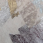 Close-up of an abstract textured surface with overlapping patches of gray, beige, and brown tones.