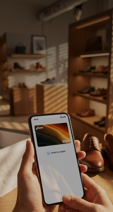 Hands holding Jim Visa card on phone in shoe store