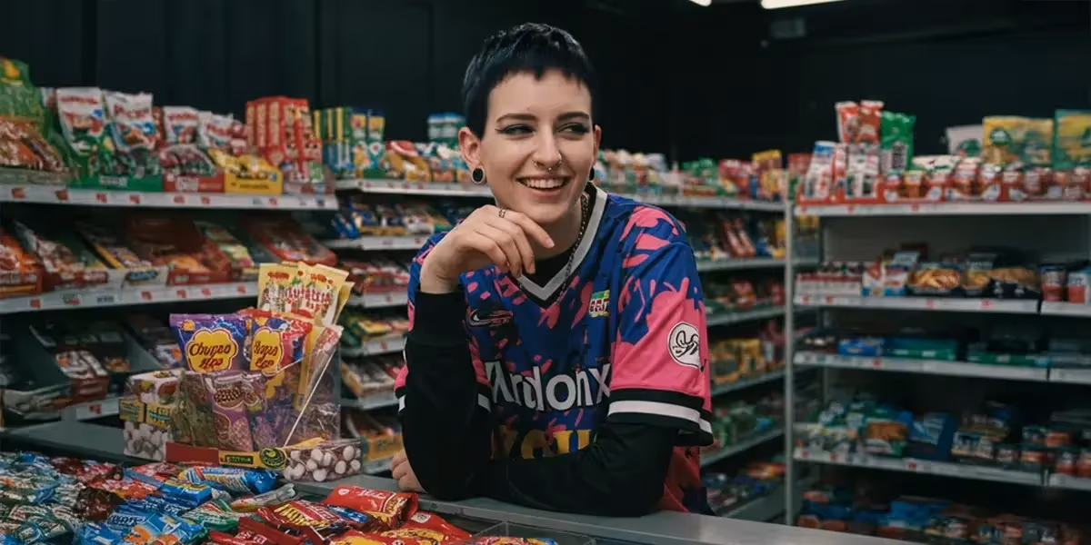 best way to accept credit cards in a small store, with a cashier standing behind a counter full of candy products.