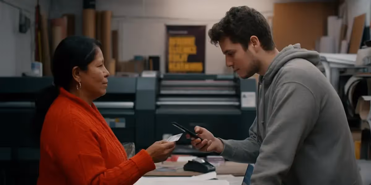 business prepaid cards being used by a woman making a transaction with a man scanning the card using his phone