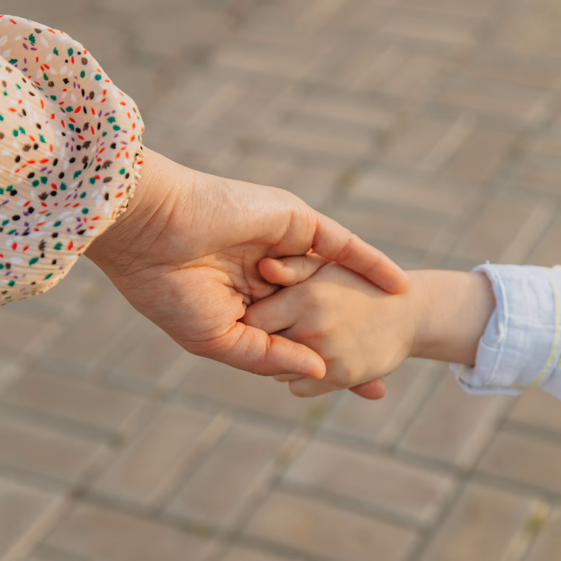 A person holding a child's hand