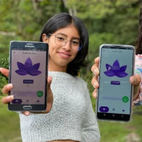 Two young women holding smartphones displaying the Lily Project mobile app, designed to provide accessible and confidential sexual health resources for young Latinas.