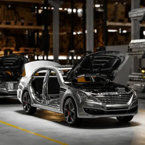 Vehicles undergoing assembly and inspection in an automotive manufacturing plant.