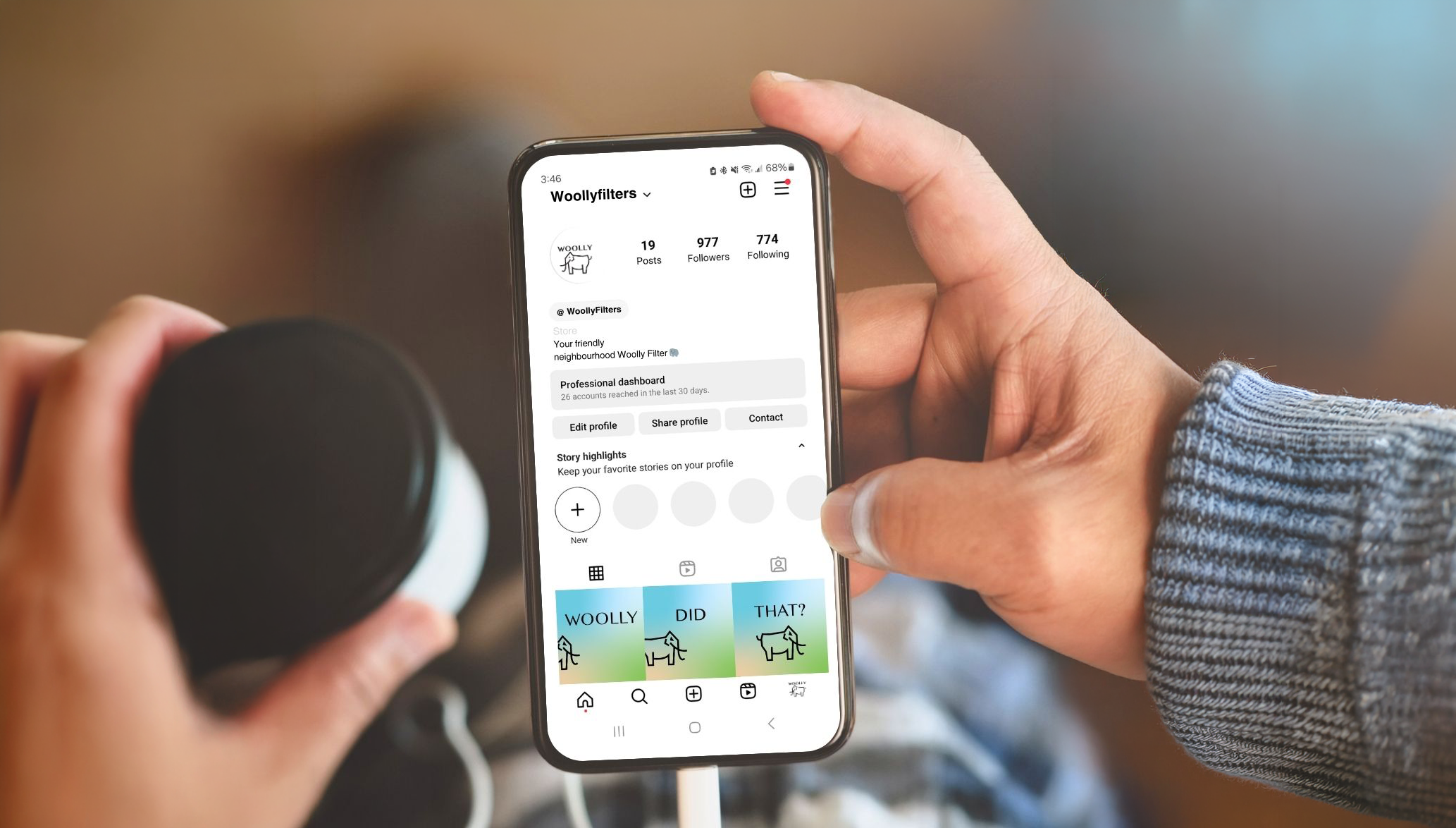 A mock image of a person holding a phone looking at a woolly furnace filters instagram page.