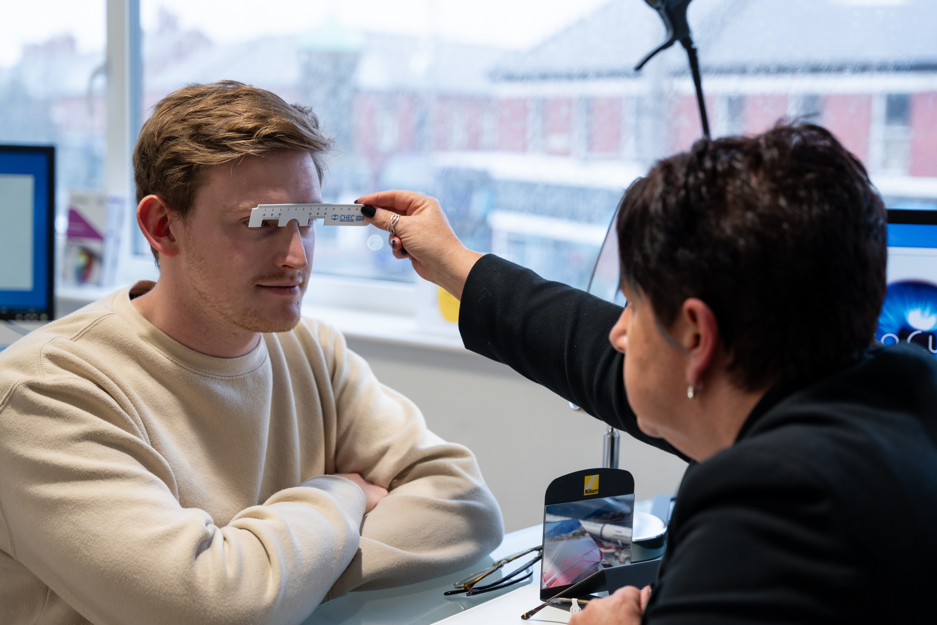 Eye measurement using specialized tool during professional vision examination