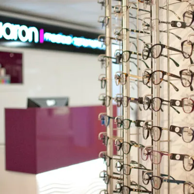 Eyeglasses display rack in optical store with reception desk