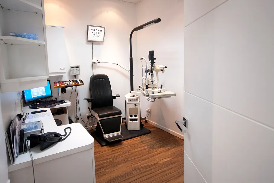 Eye doctor's examination room with medical equipment and eye chart