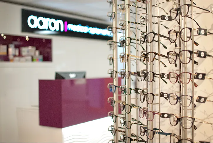 Variety of eyeglasses on display rack in Aaron optical store