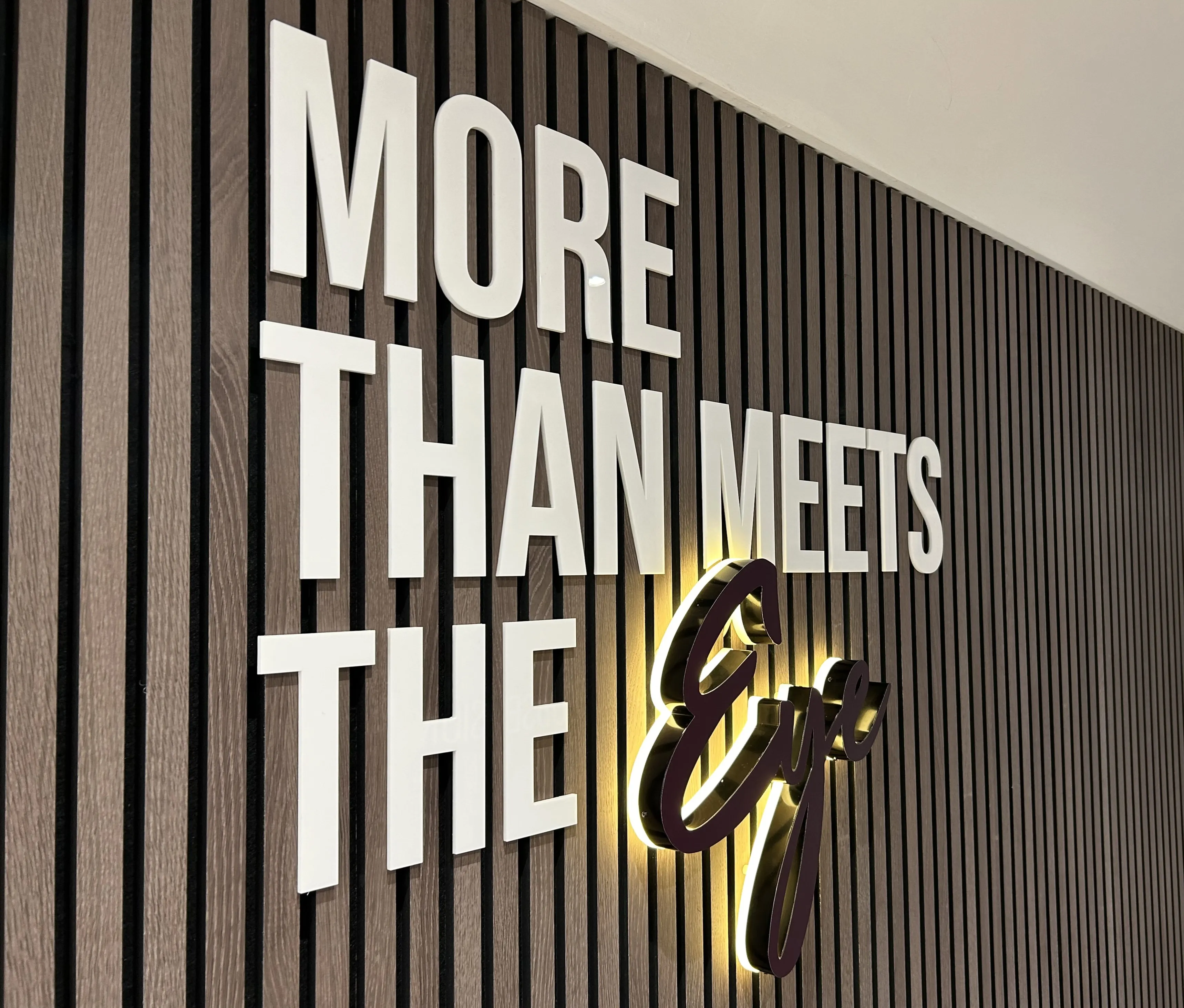 Motivational wall sign saying "More Than Meets The Eye" with backlit text