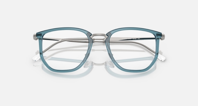 Transparent blue-green eyeglasses with silver metal arms on white background