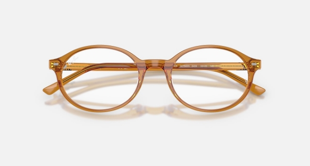 Transparent amber-colored round eyeglasses on a white background
