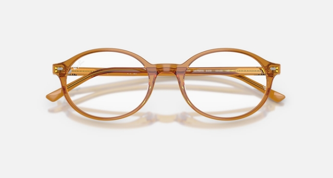 Transparent amber-colored round eyeglasses on a white background