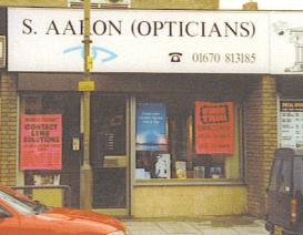 A person walking past a storeDescription automatically generated