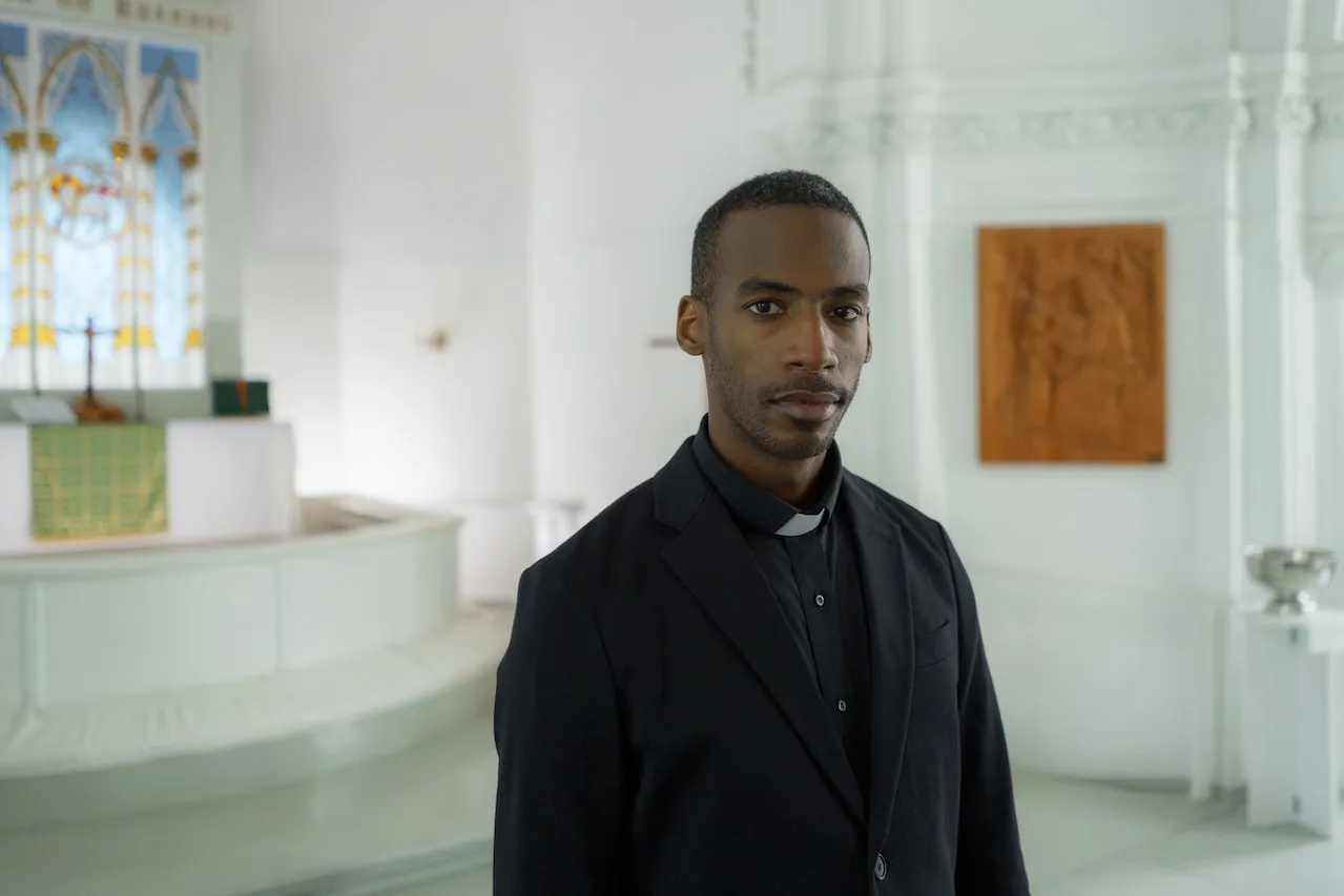 Pastor in a white room