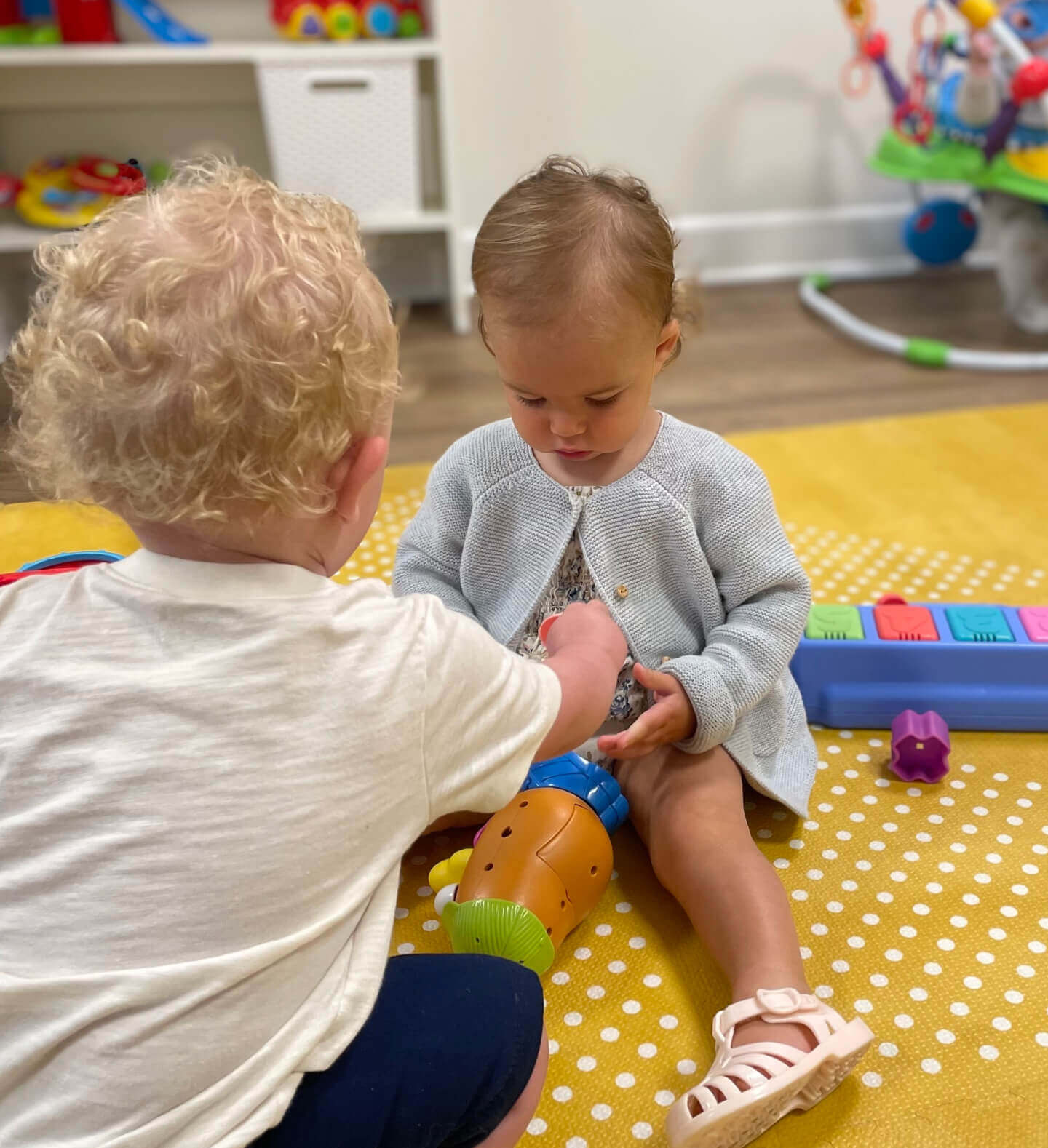 Cute image of two babies sharing blocks in the Nursery of Harvest Church, Arroyo Grande
