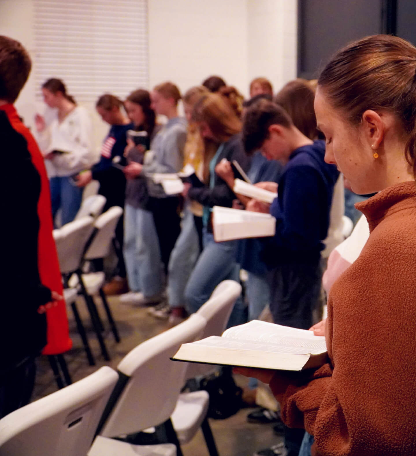 A midweek Young Heirs youth group meeting with youths reading the Bible at Harvest Church in Arroyo Grande