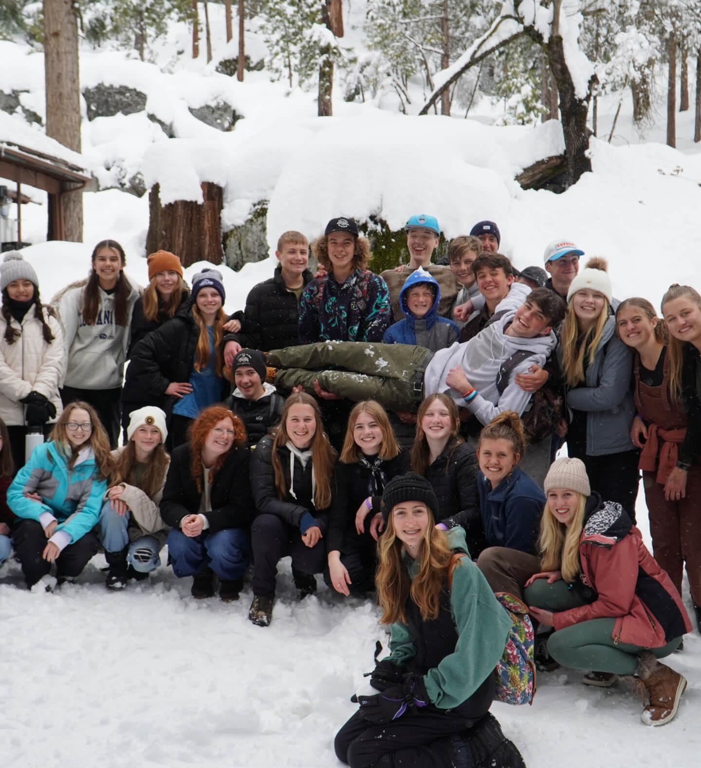 A fun and smiling photo of Harvest Church’s Young Heirs youth group during a winter trip to the snow