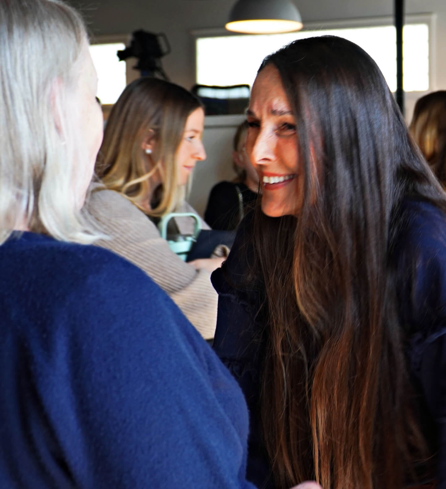 A light moment of levity as two women in the foreground are laughing during a women’s event at Harvest Church in Arroyo Grande