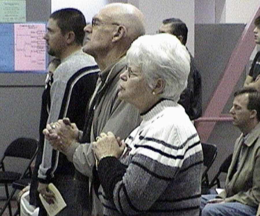 A grainy picture of an early Harvest Church service, when the church was meeting at Lopez High School