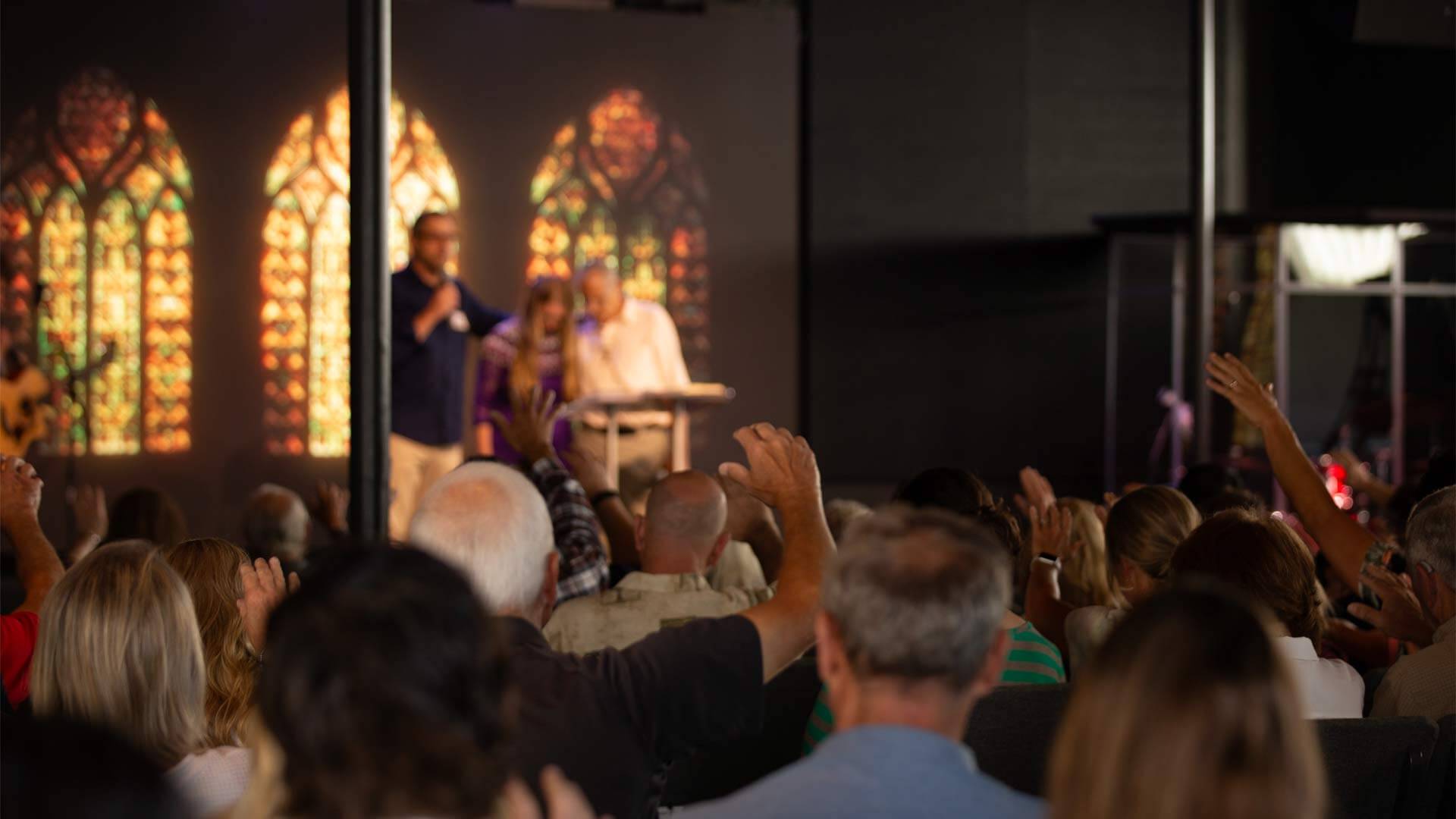 Harvest Church - Image of people praying in main sanctuary