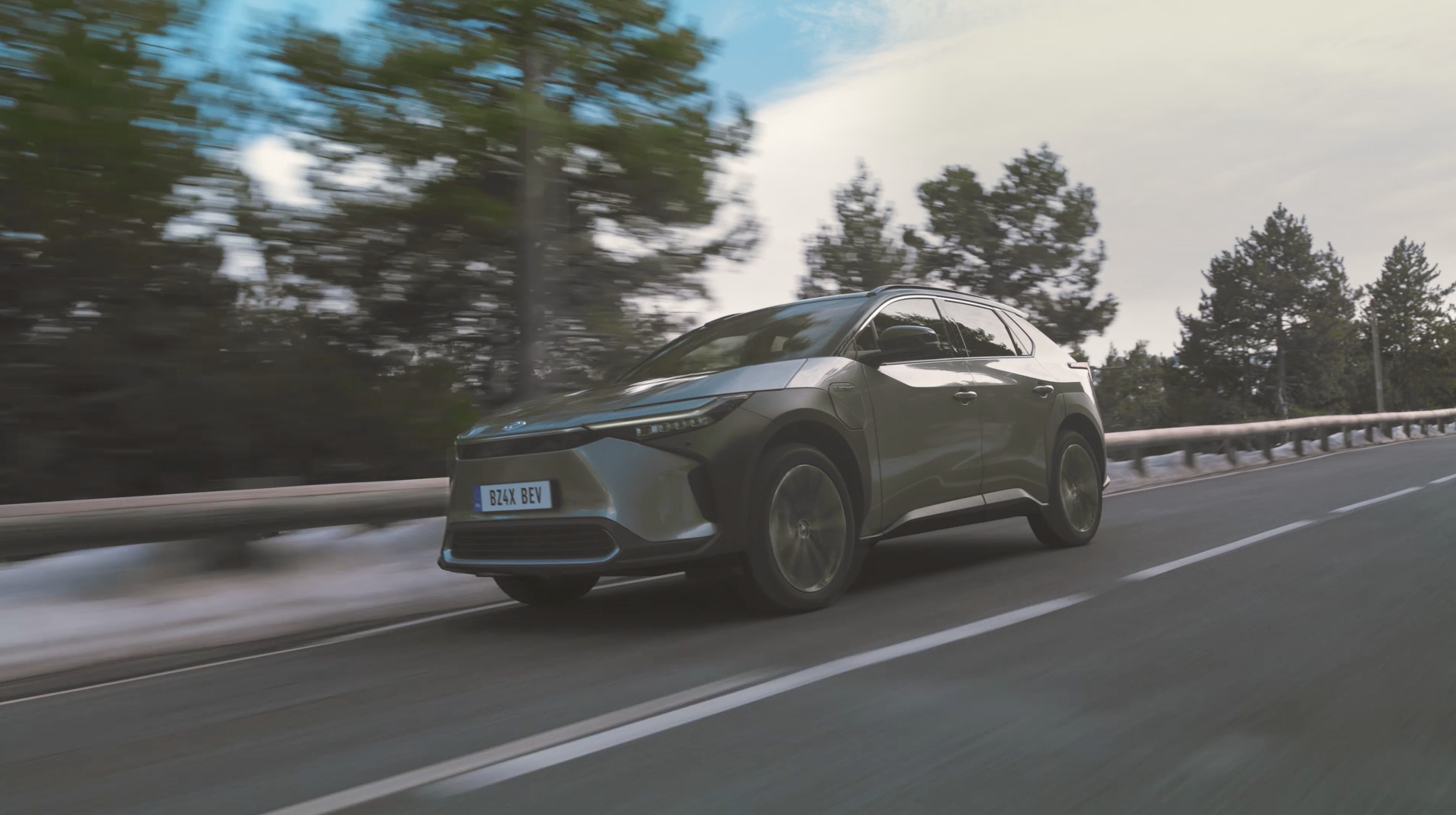 A view of people celebrating at an indoor party with food and beverages scattered on a table.