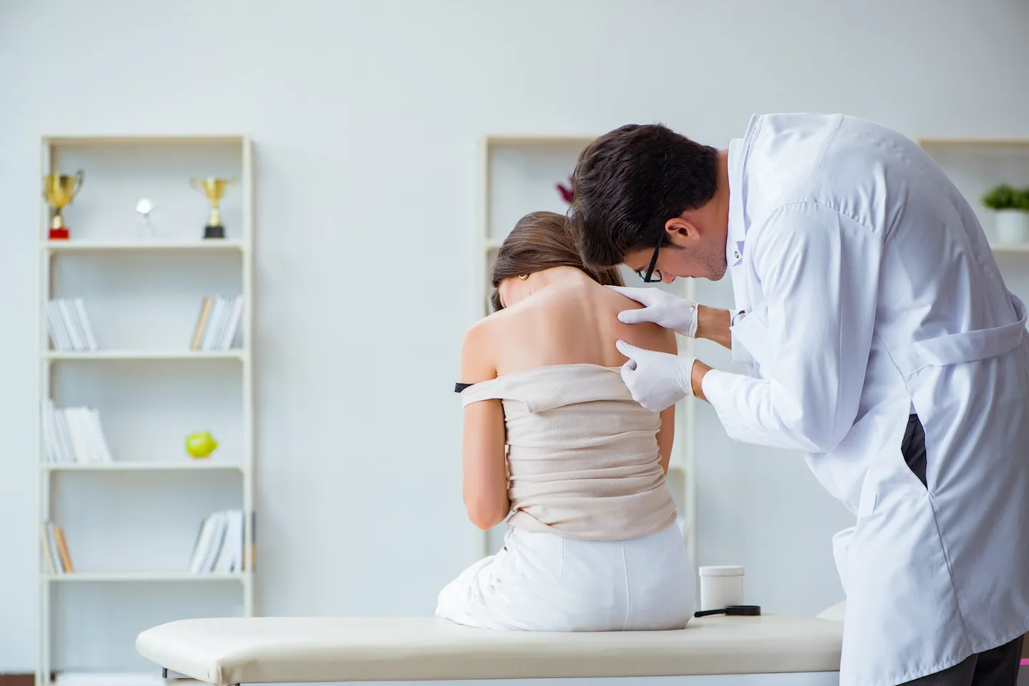 doctor examining patient's skin