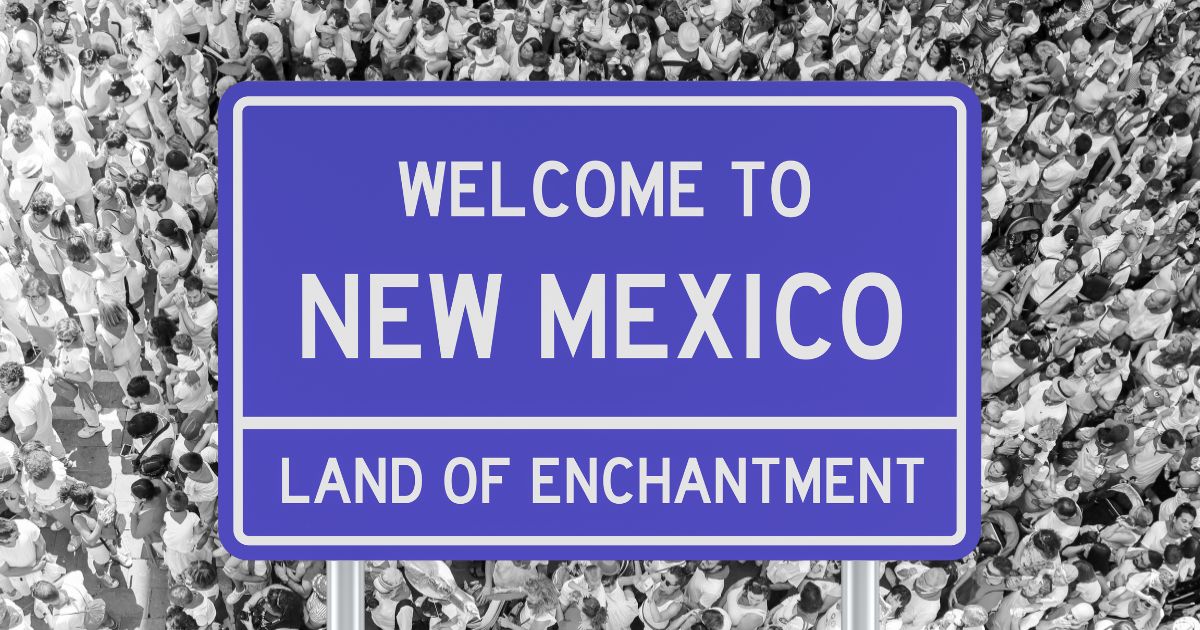 new mexico state sign with people in background