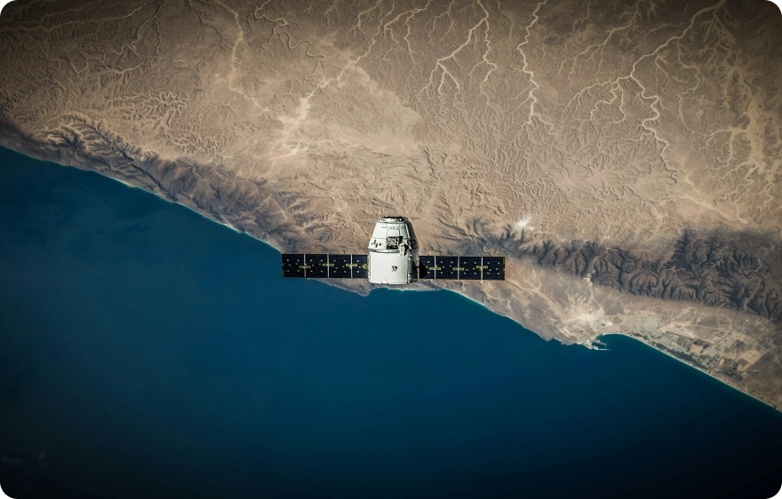SpaceX Dragon spacecraft orbiting Earth, with solar panels extended