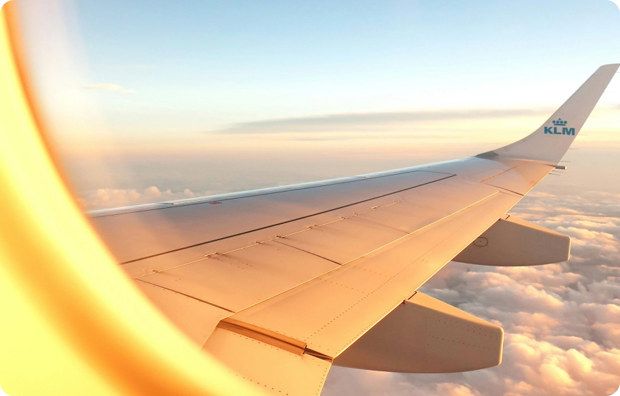 A close-up shot of an airplane wing as seen from inside the cabin
