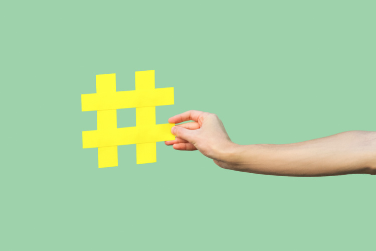hand holding hashtag symbol