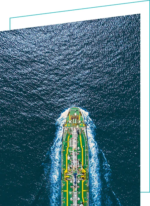 Aerial view of cargo vessel on teal ocean