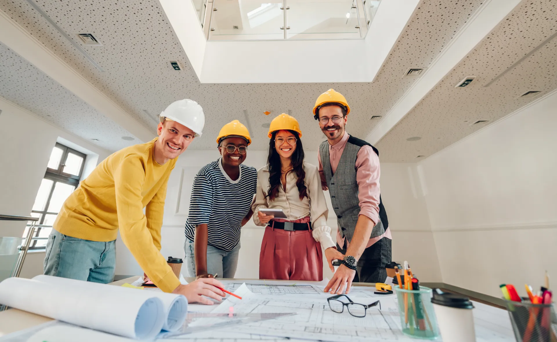 Multidisciplinary construction team reviewing project plans together as part of a Lean construction planning process.