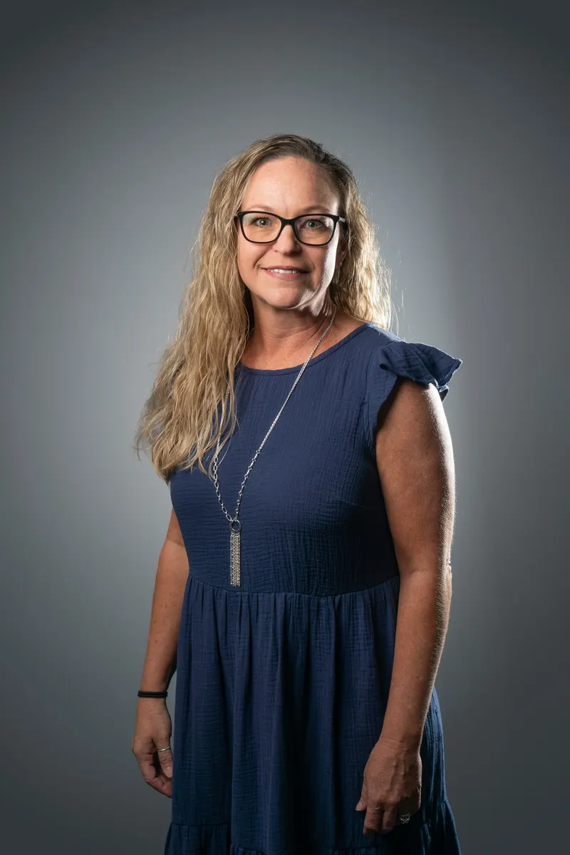 A curly-haired blonde middle aged female professional photograph.
