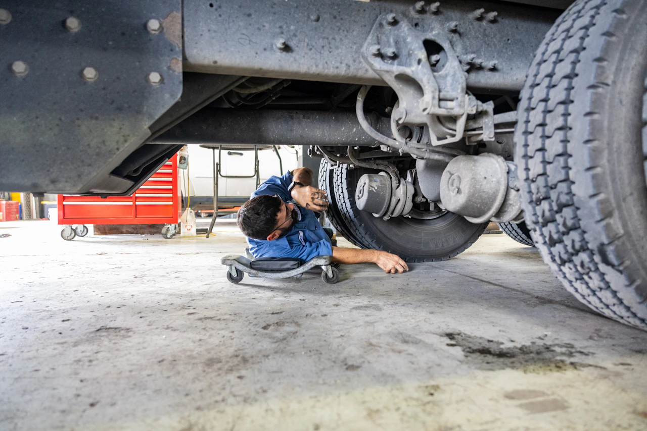 diesel mechanic working on a truck brake